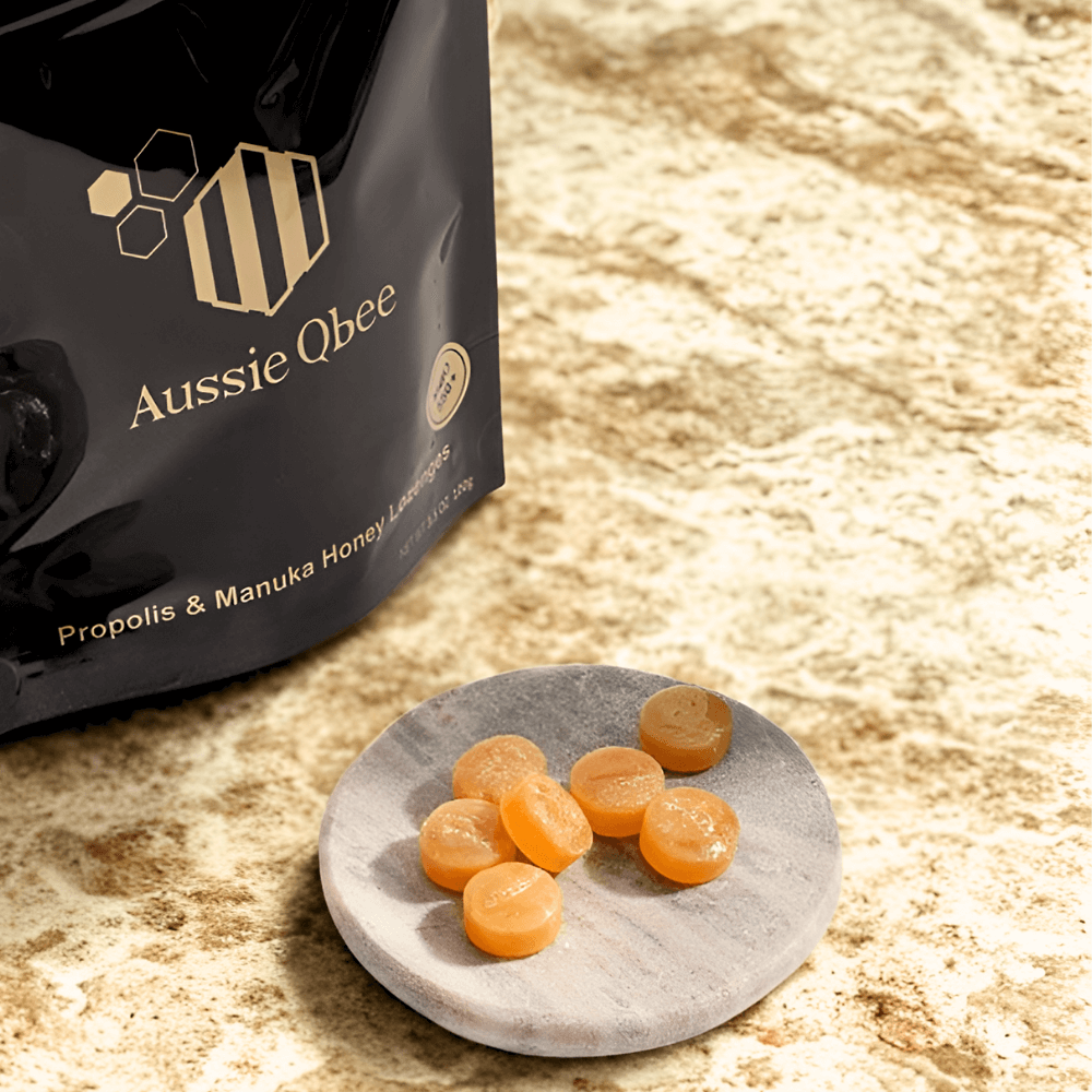 The Total Defense Kit | MGO 600+ Immunity Trio featuring Aussie Qbee Propolis & Manuka Honey lozenges on a marble plate.