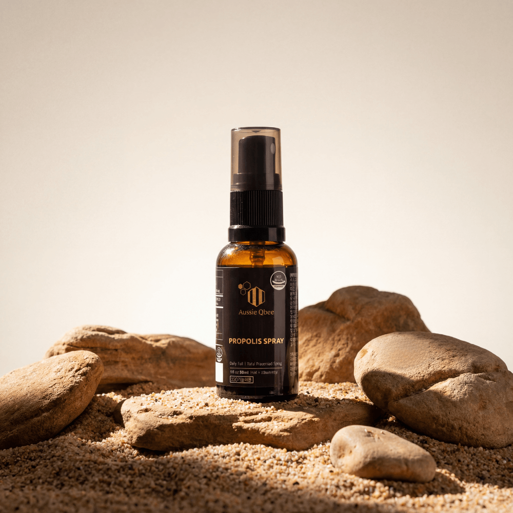The Total Defense Kit | MGO 600+ Immunity Trio  featuring Propolis Spray among sand and stones for natural immunity support.
