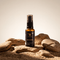 The Total Defense Kit | MGO 600+ Immunity Trio  featuring Propolis Spray among sand and stones for natural immunity support.